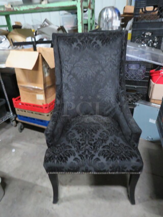 One Cushioned Chair With Nail Head Trim.
