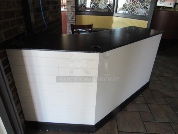 One Wooden Front Counter/Hostess Stand With Laminate Top And Under Shelves. BUYER MUST REMOVE.  70X20X36