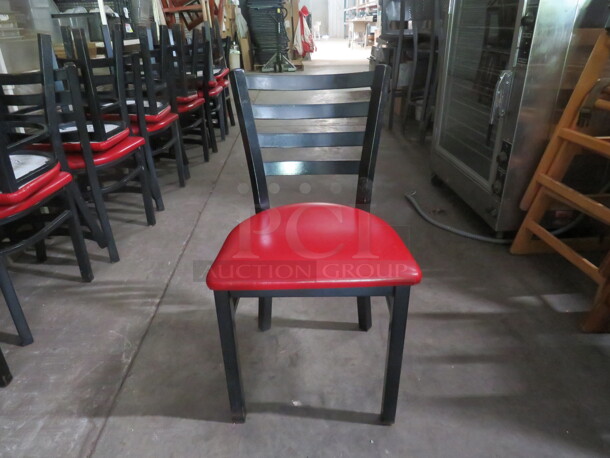 Black Metal Chair With A Red Cushioned Seat. 4XBID - Image 1 of 2