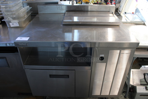 Delfield Stainless Steel Commercial Prep Table w/ Lid, Door and Backsplash on Commercial Casters. 39x32x40. Tested and Powers On But Does Not Get Cold