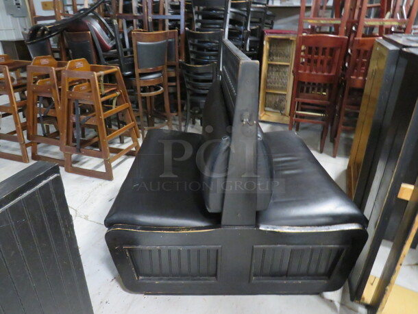 One Black Wooden Double Sided Booth With Black Cushioned Seat And Back. 45X46X36