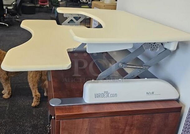 1 VariDesk Pro Plus 36 adjustable height/ sit- stand desk. Is in great condition with minor signs of use. Turn any surface into a workspace instantly! It is off white and silver metal in color and measures 4.5” to 17.5” H x 36” W. 

 - Image 3 of 3