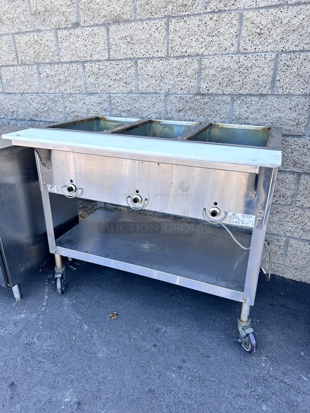 Late Model Duke E303 44 inch Hot Food Table w/ (3) Wells & Cutting Board, On Casters 115v/1ph Working - Item #1108537