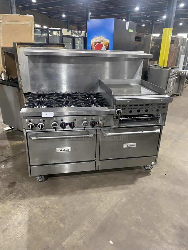 BEAUTIFUL! GARLAND All Stainless Steel Natural Gas Powered 6 Burner Range W/ Raised Right Side Flat Top W/ Cheese Melter! With 2 Ovens W/ Metal Racks! With Raised Over Back Splash & Slamander Shelf! On Commercial Casters! Working When Removed! - Image 1 of 9