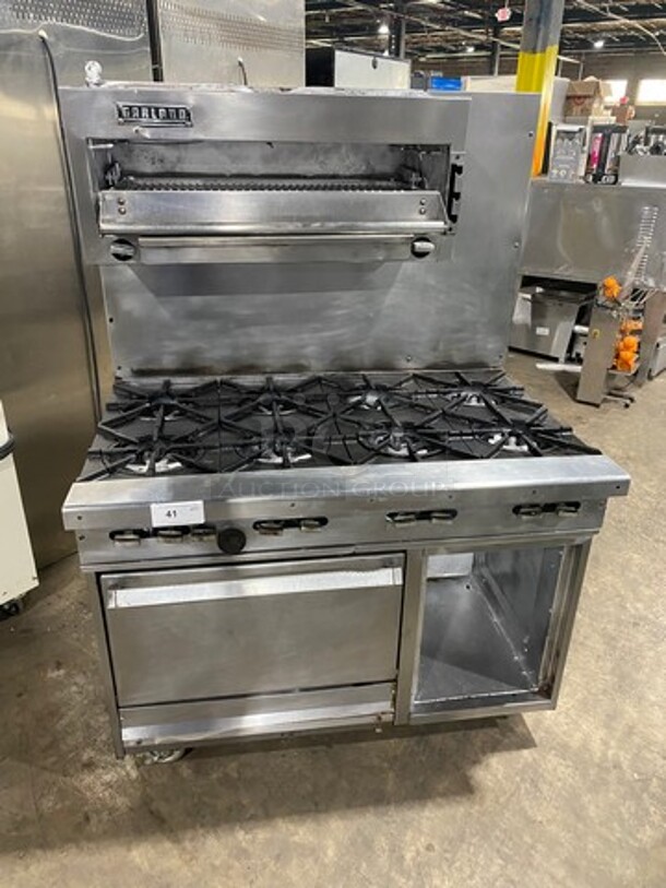 Garland Commercial Gas Powered 8 Burner Stove! With Raised Back Splash And Salamander! With Oven Underneath! All Stainless Steel! On Casters! - Image 1 of 11
