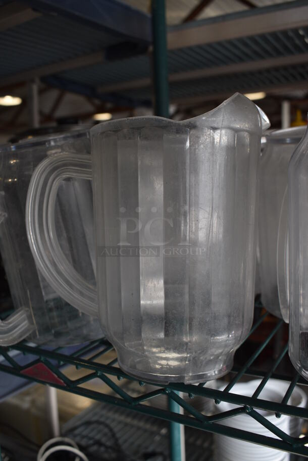 ALL ONE MONEY! Lot of 16 Clear Poly Pitchers! 7x5x8 - Image 1 of 4