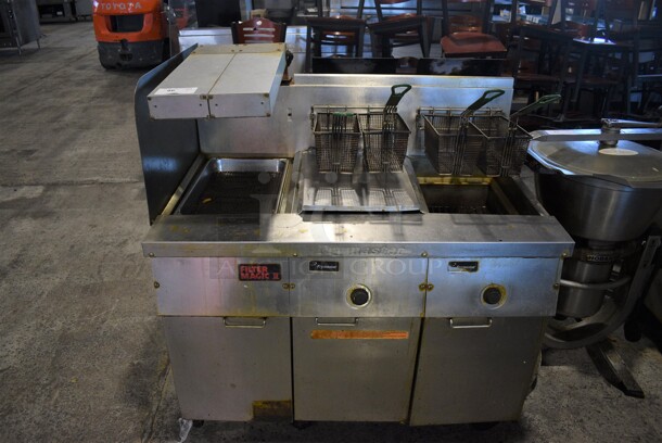 Frymaster Model FM235SD Stainless Steel Commercial Propane Gas Powered Deep Fat Fryer w/ Left Side Dumping Station, 4 Baskets and Lid on Commercial Casters. 110,000 BTU. 47x32x51