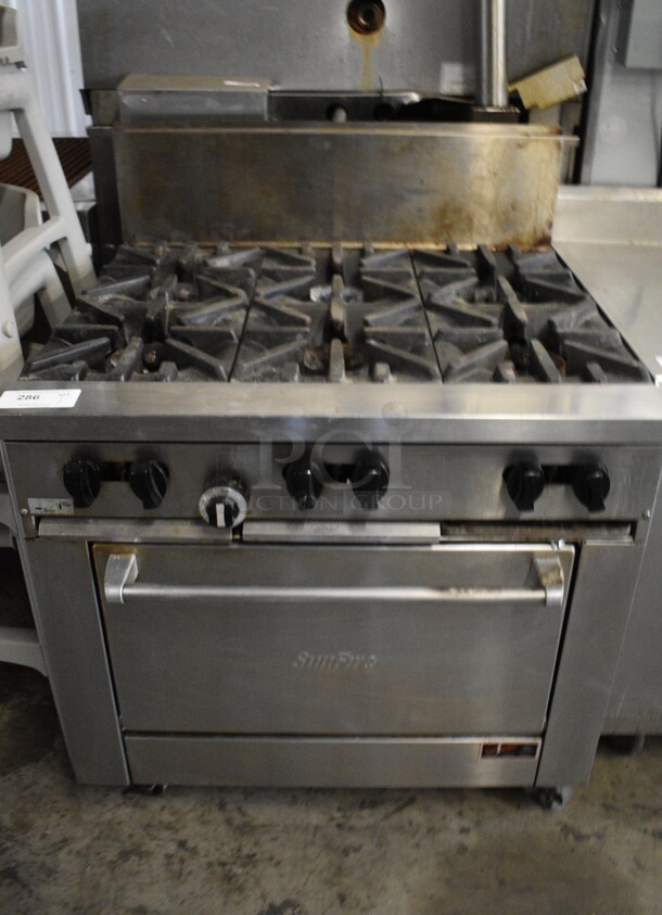 Garland SunFire Stainless Steel Commercial Natural Gas Powered 6 Burner Range w/ Oven and Back Splash on Commercial Casters. 36x34x45