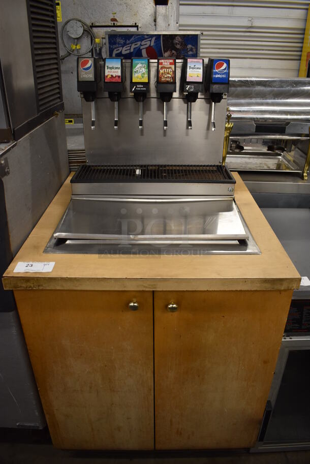 Stainless Steel Commercial 6 Flavor Carbonated Beverage Machine w/ Drop In Ice Bin on Wood Pattern Counter. 30.5x34x59