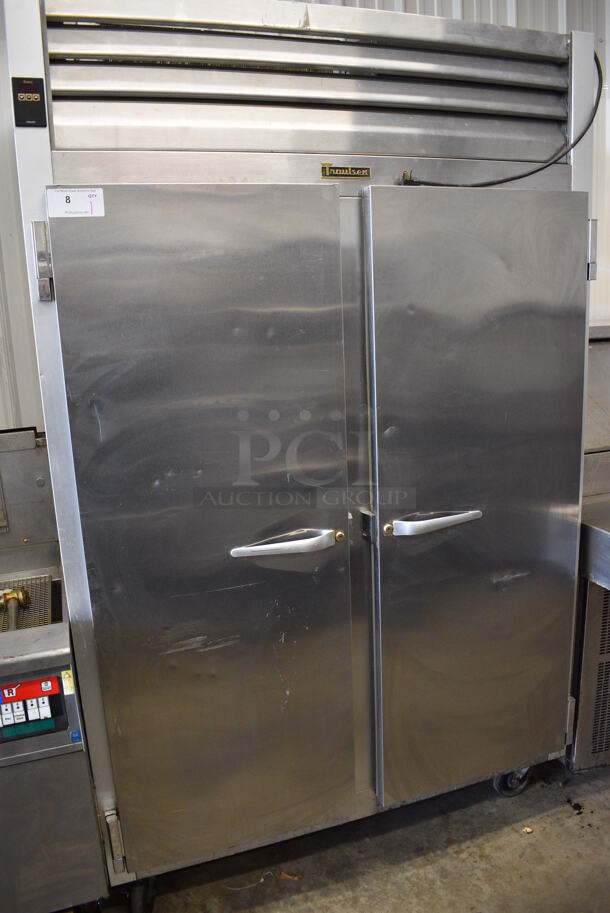 Traulsen Model G22010 ENERGY STAR Stainless Steel Commercial 2 Door Reach In Freezer w/ Poly Coated Racks on Commercial Casters. 115 Volts, 1 Phase. 31.5x34x79. Tested and Working!