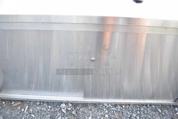 BRAND NEW SCRATCH AND DENT! Regency 600EBT2472R 24" x 72" 16 Gauge Type 304 Stainless Steel Enclosed Base Sliding Door Table with Drawers - Image 5 of 6