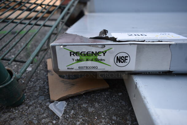 BRAND NEW SCRATCH AND DENT! Regency 600TB3096G 30" x 96" 18-Gauge 304 Stainless Steel Commercial Work Table with 4" Backsplash and Galvanized Undershelf - Image 5 of 6