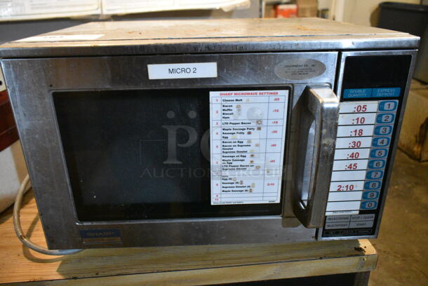 Sharp R-23GT Stainless Steel Commercial Countertop Microwave Oven. 120 Volts, 1 Phase. This Unit Was In Working Condition When the Restaurant Closed. (basement)  - Image 1 of 4