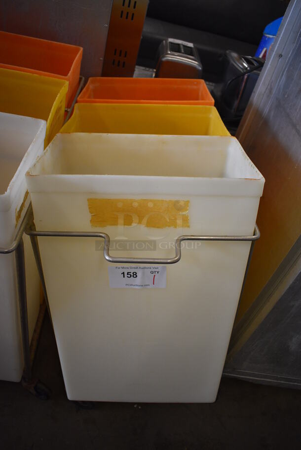 Three Poly Ingredient Bins; White, Yellow and Orange in Metal Frame on Commercial Casters. No Lids. Missing 1 Caster. 15x32x28