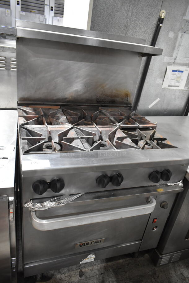 Vulcan Stainless Steel Commercial Natural Gas Powered 6 Burner Range w/ Convection Oven, Over Shelf and Back Splash on Commercial Casters. 