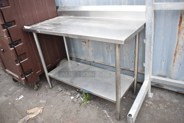 Stainless Steel Table w/ Back Splash and Under Shelf.  - Image 1 of 3