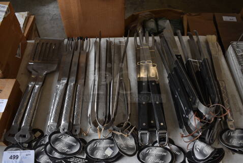 ALL ONE MONEY! Lot of BRAND NEW Utensils Left To Right; 6 Spatulas, 10 Steak Forks, 5 Tongs, 8 Steak Forks, 6 Tongs and 2 Brushes.