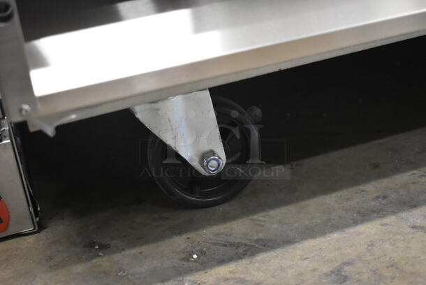 BRAND NEW SCRATCH AND DENT! 2023 Avantco 178SS3FHC Stainless Steel Commercial 3 Door Reach In Freezer w/ Poly Coated Racks on Commercial Casters. 115 Volts, 1 Phase. Tested and Working! - Image 5 of 11