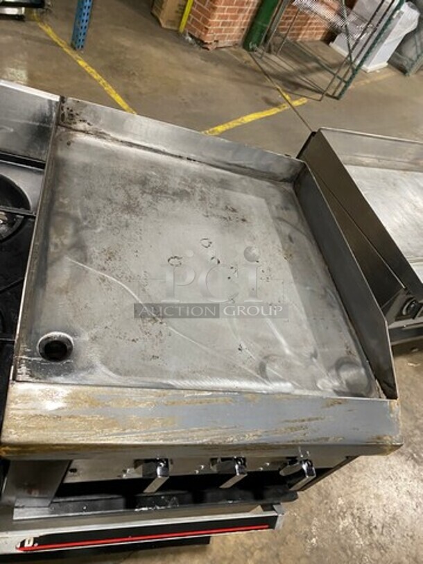 Garland Commercial Gas Powered 6 Burner Stove With Right Side Flat Griddle! Griddle Has Side Splashes! With Back Splash! With 2 Oven Underneath! Metal Oven Racks! All Stainless Steel! On Casters! - Image 7 of 12