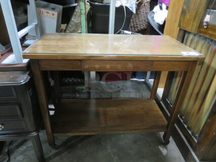 One Wooden Table With 1 Drawer And Under Shelf, With Glass Top, On Casters. 43X20.5X34.5