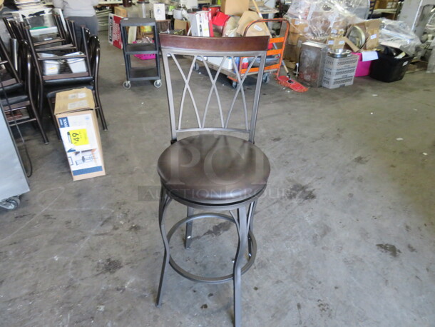 One Metal Bar Height Chair With Cushioned Swivel Seat And Footrest.