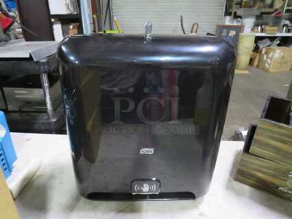 One Tork Automatic Hands Free Paper Towel Dispenser. 