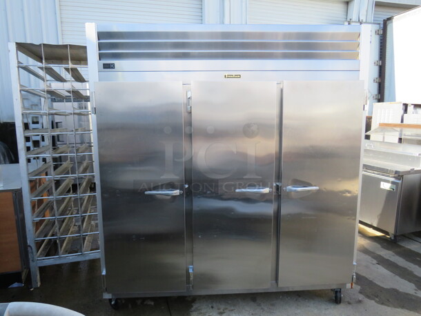 One Working Stainless Steel Traulsen 3 Door Refrigerator, With 9 Racks,  On Casters. Model# G30011. 115 Volt. 77X35X83.5. $9176.00. 