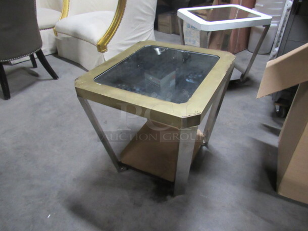One Side Table In Gold With A Glass Top And Under Shelf. 22X24X23