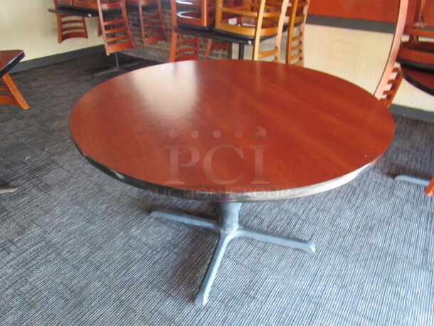 One Round Table With Laminate Top On A Pedestal Base. 48X48X30
