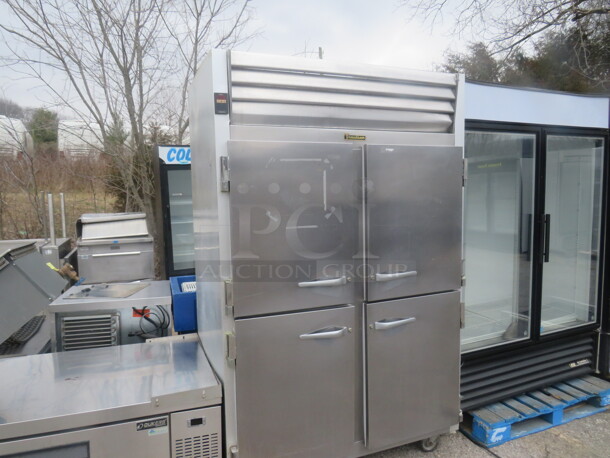 One Stainless Steel Traulsen 2 Section Half Door Refrigerator With 3 Racks On Casters. Model# G2000. 115 Volt. 52X35X83 - Image 1 of 3