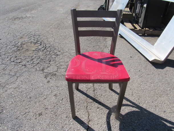Brown Metal Chair With A Red Poly Seat. 2XBID