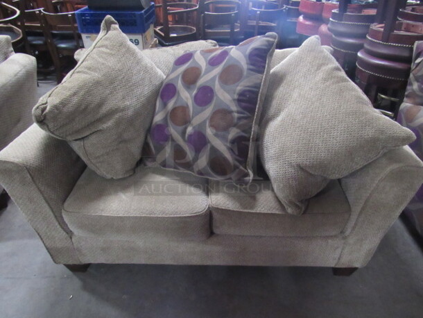 One Overstuff Beige Loveseat With 3 Assorted Pillows. 60X32X31