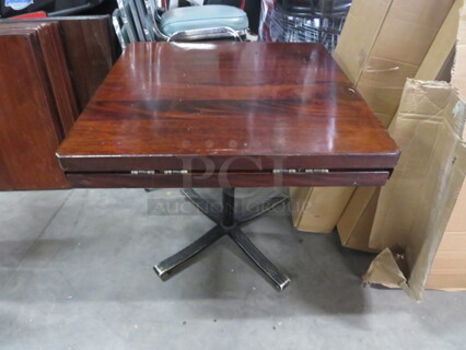 One Square Solid Wooden Table With Flip Up Sides To Create A 43 Inch Round Table On A Pedestal Base. 32X32X30, 43X43X30. 