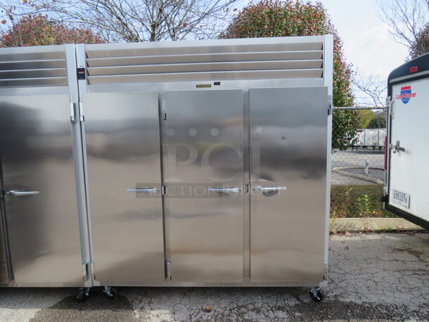One WORKING Stainless Steel Traulsen 3 Door Refrigerator With 9 Racks On Casters. 115 Volt. #G30011. 77X35X83.5