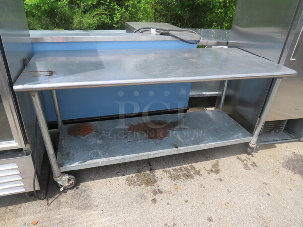 One Stainless Steel Table With Under Shelf On Casters. 72X30X33