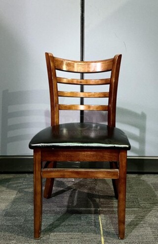 Wooden restaurant chair with black leather seat- 18.5" W x 33.5" L x 15" D. In good used condition, no broken pieces but have some marks and scuffs from normal wear. BIDX6