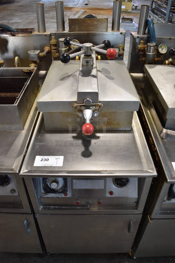 Henny Penny Model 600 Stainless Steel Commercial Floor Style Natural Gas Powered Pressure Fryer w/ Fry Basket on Commercial Casters. 18x39x50