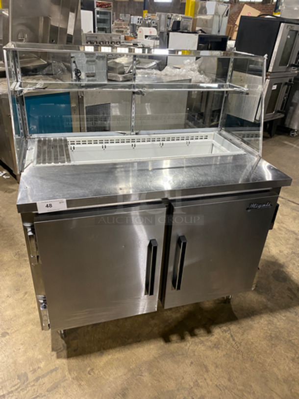 NICE! Migali Commercial Refrigerated Prep Table! With View Through Over Head Shelves! With 2 Door Storage Space Underneath! Poly Coated Racks! All Stainless Steel! On Legs! Model: CA412 SN: 05067286 115V 60HZ 1 Phase