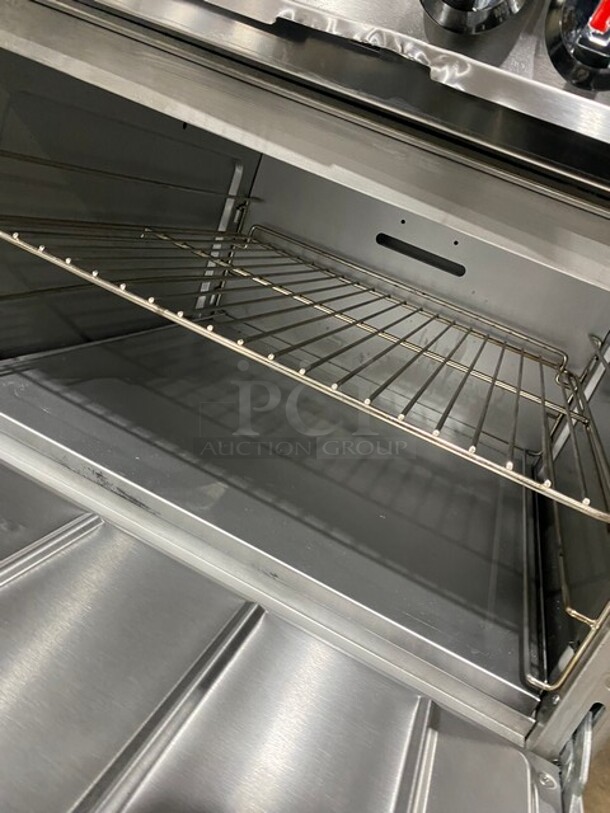 CPG Commercial LP Powered Flat Top Griddle Stove With Left Side 2 Burner! Griddle Has Side Splashes! With Raised Back Splash And Salamander Shelf! With 2 Oven Underneath! Metal Oven Racks! All Stainless Steel! On Casters! Working When Removed! Model: S60G48L SN: 09227429 - Image 9 of 12