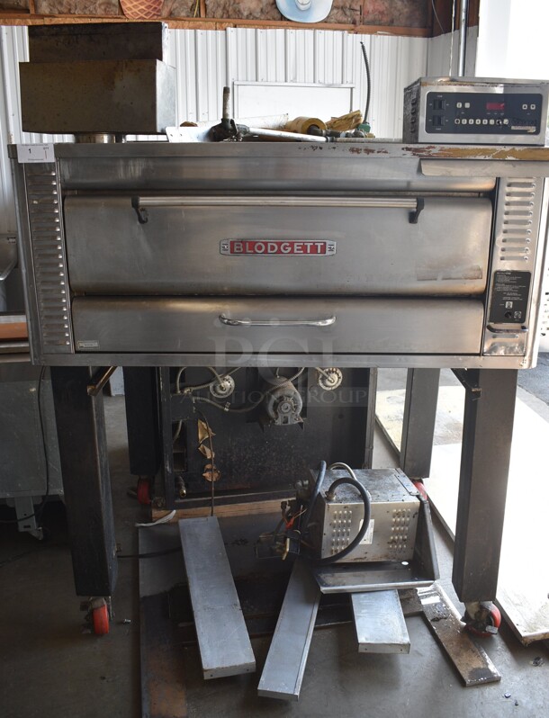 Blodgett Model 1048DD/AA-S Stainless Steel Commercial Natural Gas Powered Single Deck Pizza Oven on Metal Legs w/ Commercial Casters. Comes w/ 2 Cooking Stones. Unit Has An Added Humidity Steam Box Attachment For Donut Baking. 80,000 BTU. 60.5x45.5x72.5 - Image 1 of 12