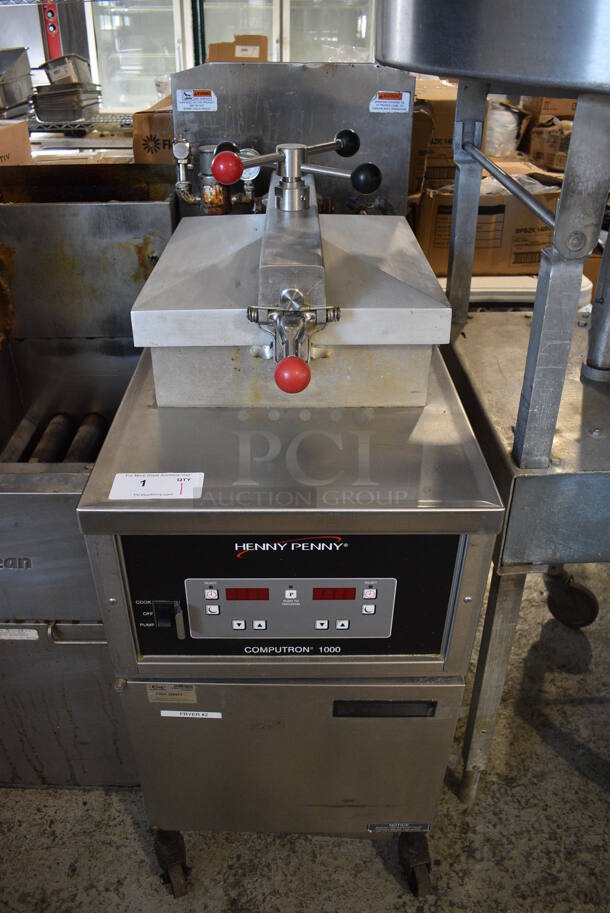 Henny Penny Model 600 Stainless Steel Commercial Floor Style Natural Gas Powered Pressure Fryer on Commercial Casters. 80,000 BTU. 18.5x38x49
