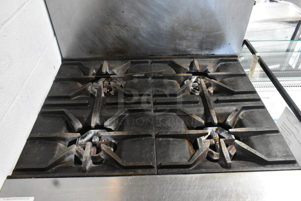 US Range C836-7 Stainless Steel Commercial Natural Gas Powered 4 Burner Range w/ Oven and Back Splash on Commercial Casters.  - Image 4 of 9