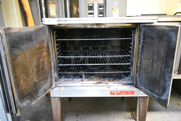 Blodgett Mark V Stainless Steel Commercial Electric Powered Full Size Convection Oven w/ Solid Doors, Metal Oven Racks and Thermostatic Controls on Metal Legs. This Unit Was In Working Condition When the Restaurant Closed. (kitchen) - Image 2 of 9