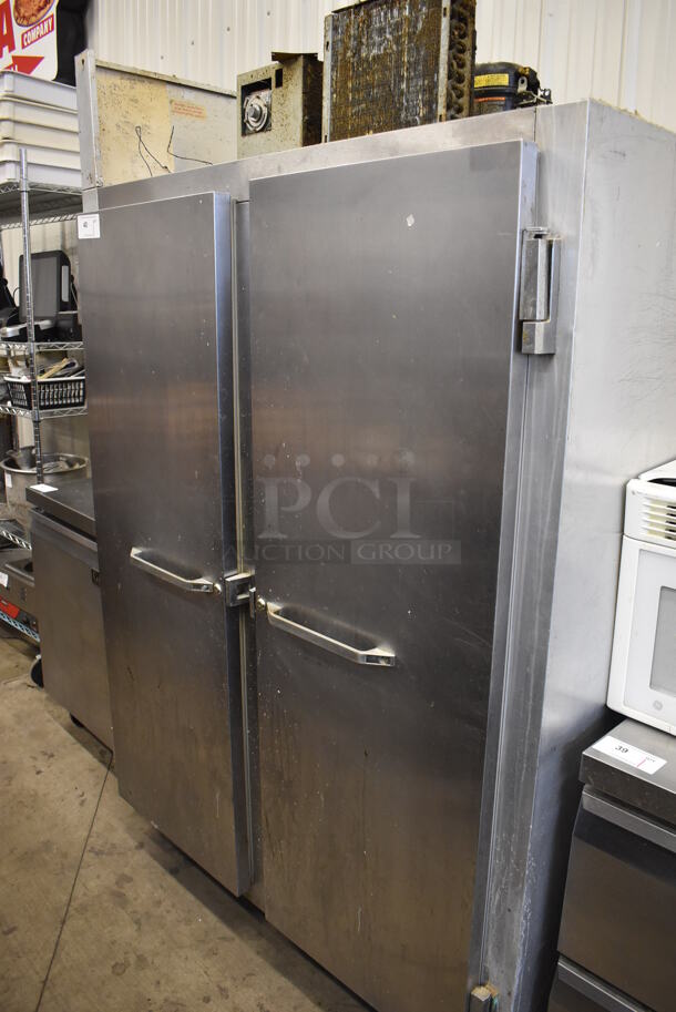 Continental 2F Stainless Steel Commercial 2 Door Reach In Freezer w/ Poly Coated Racks on Commercial Casters. 115 Volts, 1 Phase. 52x34x82. Tested and Powers On But Does Not Get Cold