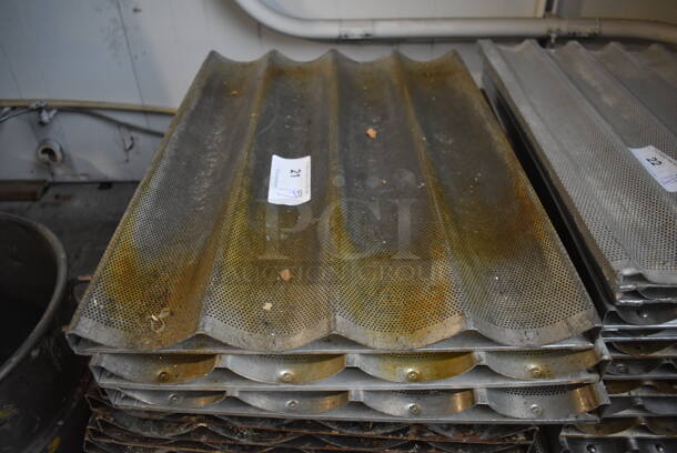 17 Metal Perforated 4 Loaf Baking Pans. 18x26x1. 17 Times Your Bid! - Image 1 of 3