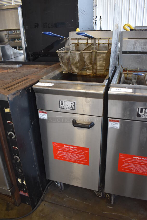 	2019 USR Cookline CF-40 Stainless Steel Commercial Floor Style Natural Gas Powered Deep Fat Fryer w/ 2 Metal Fry Baskets, Right Side Splash Guard and Adapter on Commercial Casters. 90,000 BTU. 16x30x51 - Image 3 of 7
