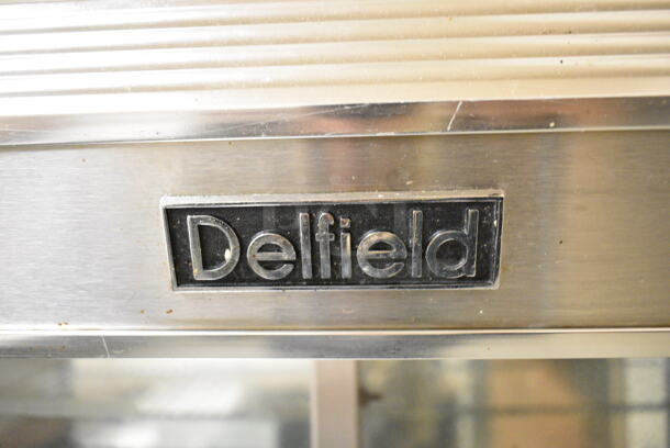 Delfield Stainless Steel Commercial Refrigerated Prep Table w/ 2 Lower Doors. BUYER MUST REMOVE: Bring Tools and Manpower Needed To Remove This Item. This Unit Was In Working Condition When the Restaurant Closed. (kitchen entryway) - Image 7 of 7