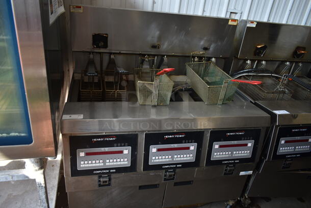 2016 Henny Penny OGA-323 ENERGY STAR Stainless Steel Commercial Natural Gas Powered 3 Bay Fryer w/ 4 Metal Fry Baskets on Commercial Casters. 255,000 BTU. 