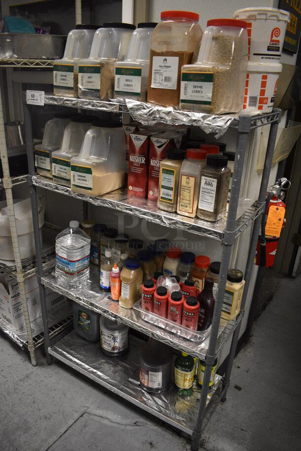 Gray Finish 4 Tier Wire Shelving Unit w/ Contents Including Seasonings. BUYER MUST REMOVE. BUYER MUST DISMANTLE. PCI CANNOT DISMANTLE FOR SHIPPING. PLEASE CONSIDER FREIGHT CHARGES. 36x14x54.5. (kitchen)