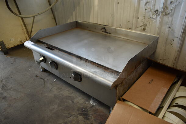APW Wyott Stainless Steel Commercial Countertop Natural Gas Powered Flat Top Griddle.  - Image 2 of 7
